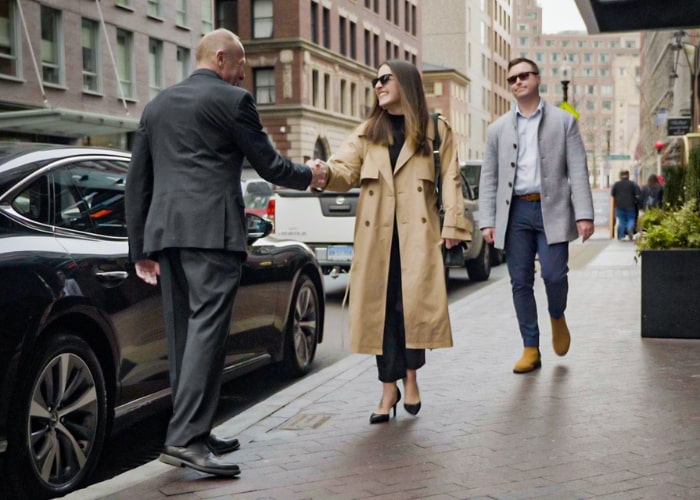 man and woman greet a private driver