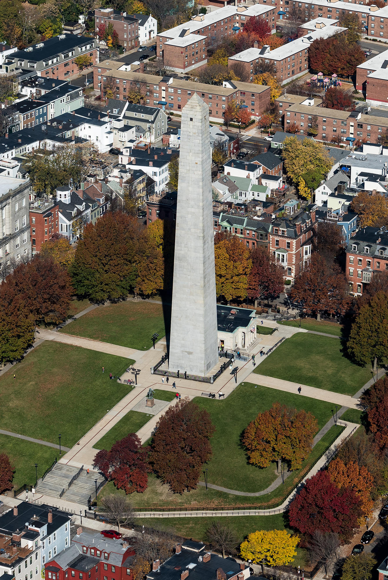 View from above of the Bunker Hill Monument surrounded by historic buildings and fall foliage in Boston