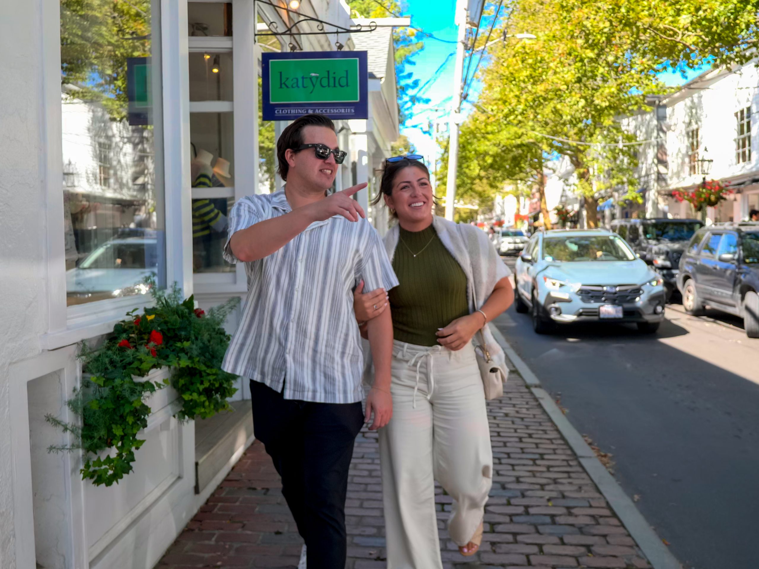 Couple walking past a storefront on Commercial Street in Provincetown.