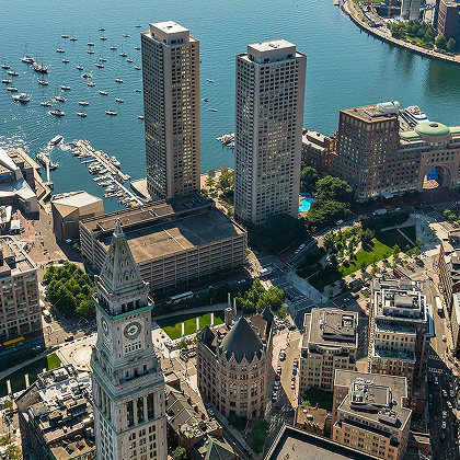 Aerial view of downtown Boston with historic buildings, high-rises, and harbor views.