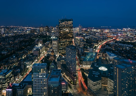 view of the Boston skyline from above at night